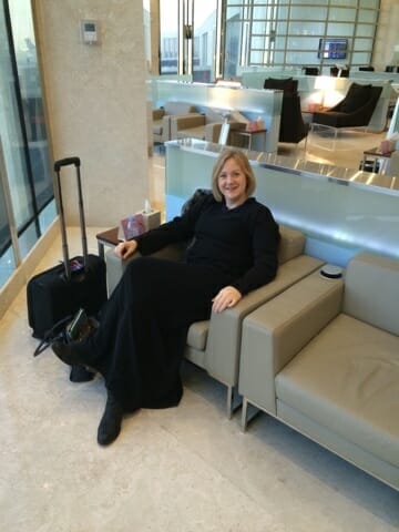 Me in my abaya lounging at the airport - what to wear in Saudi Arabia