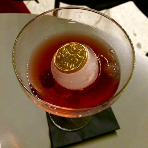 Chocolate coin embedded in the spherical ice block in the Member's Club cocktail