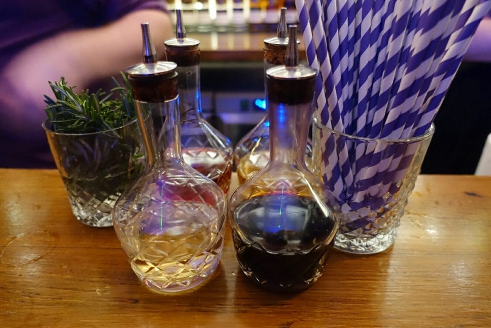 Bitters bottles lined up on the bar
