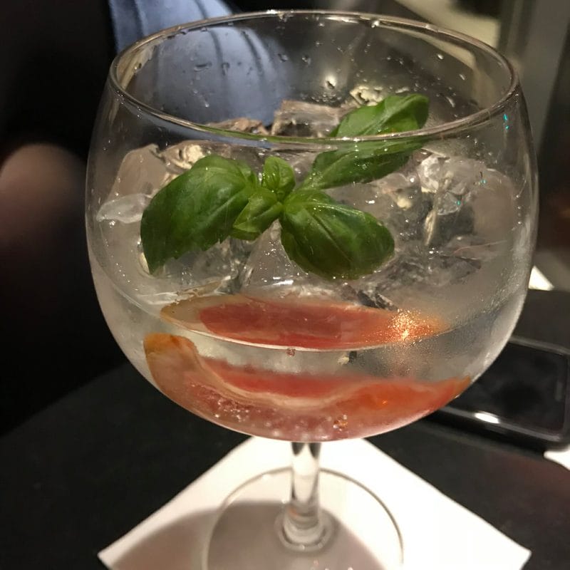Gin garnished with basil and grapefruit