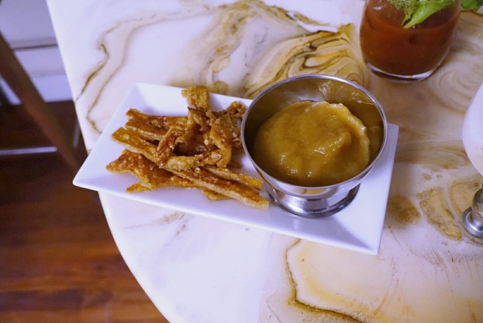 Pork scratching nibbles with apple sauce