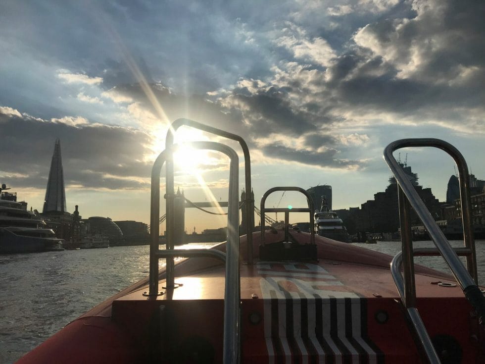 View of London from the Thames Rockets boat with the sun coming out from behind a cloud