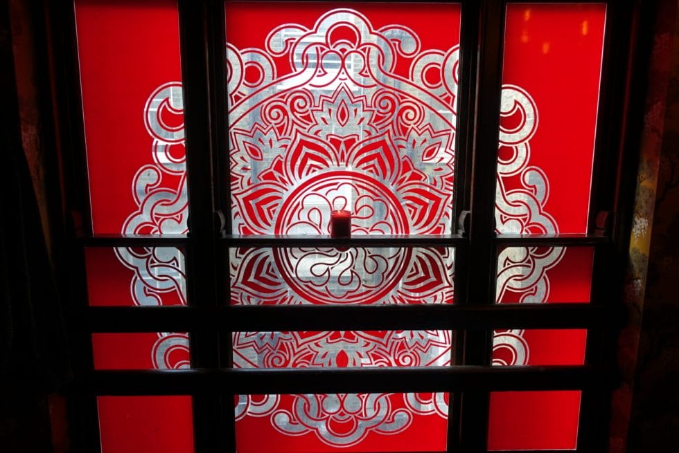 Red design on the window the Peony room at Opium