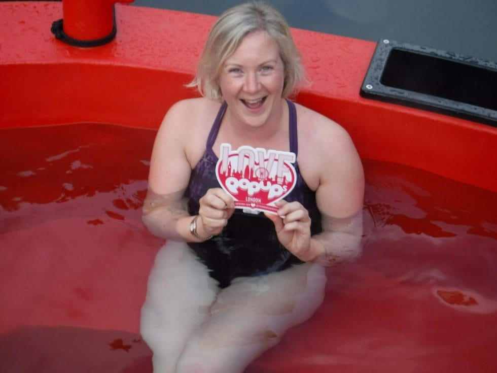 Katie holding the Love Pop Ups London sign in the HotTug