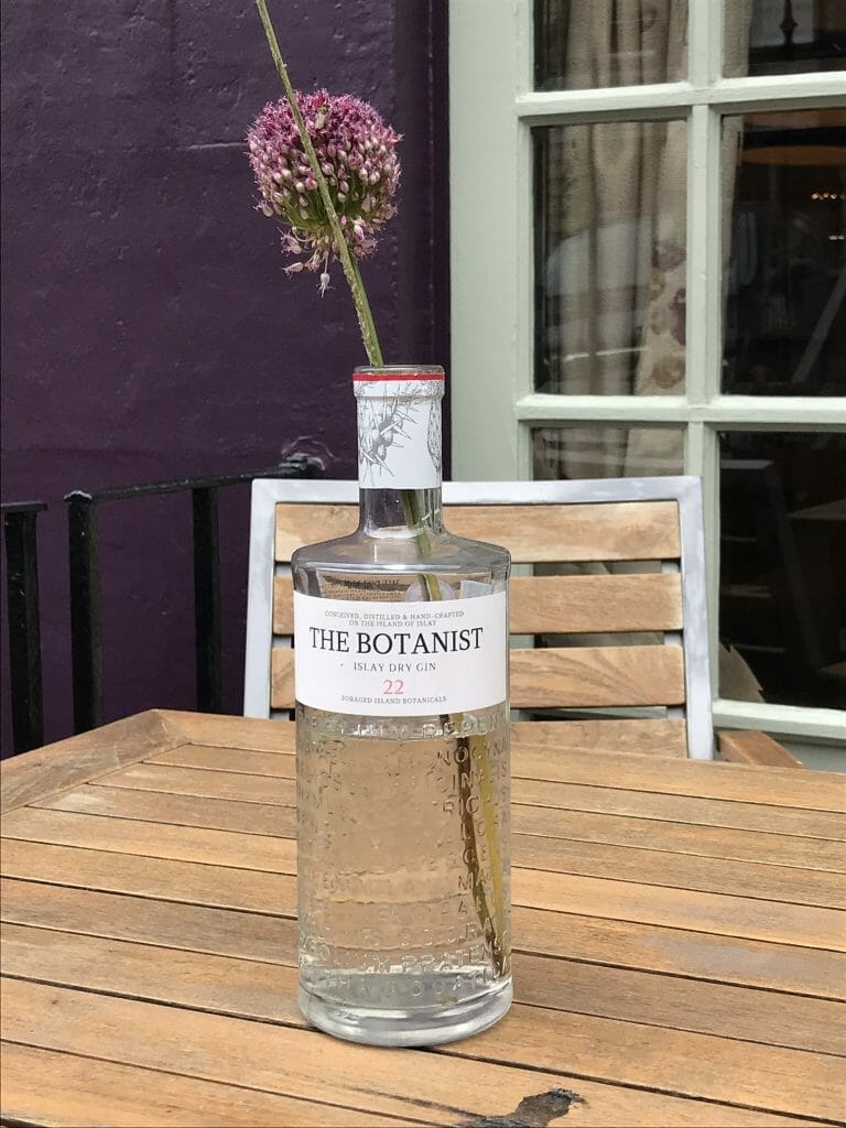 The beautiful Botanist bottle on a table outside the bar