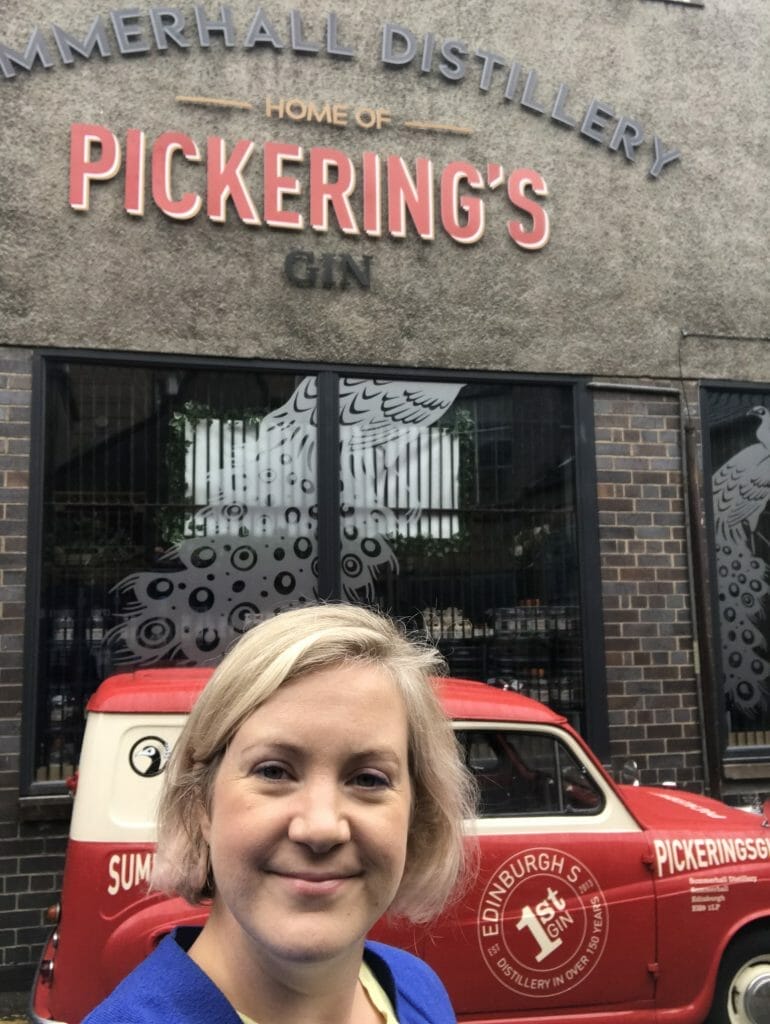 Katie posing outside of Pickering's distillery