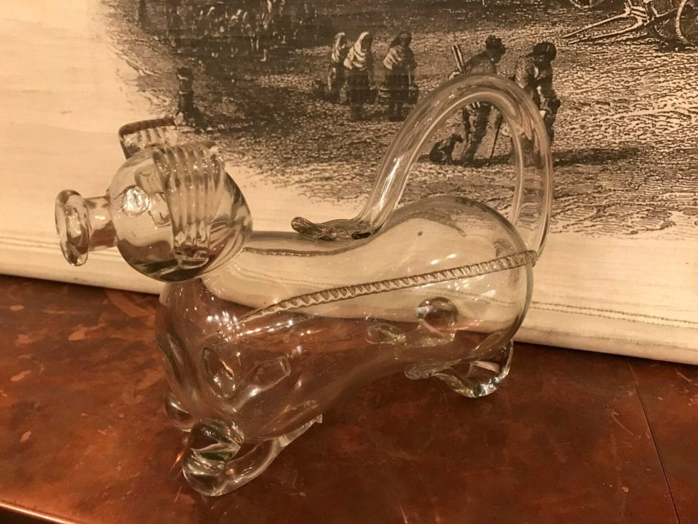 A glass pig container made to carry gin for the classy Victorian lady