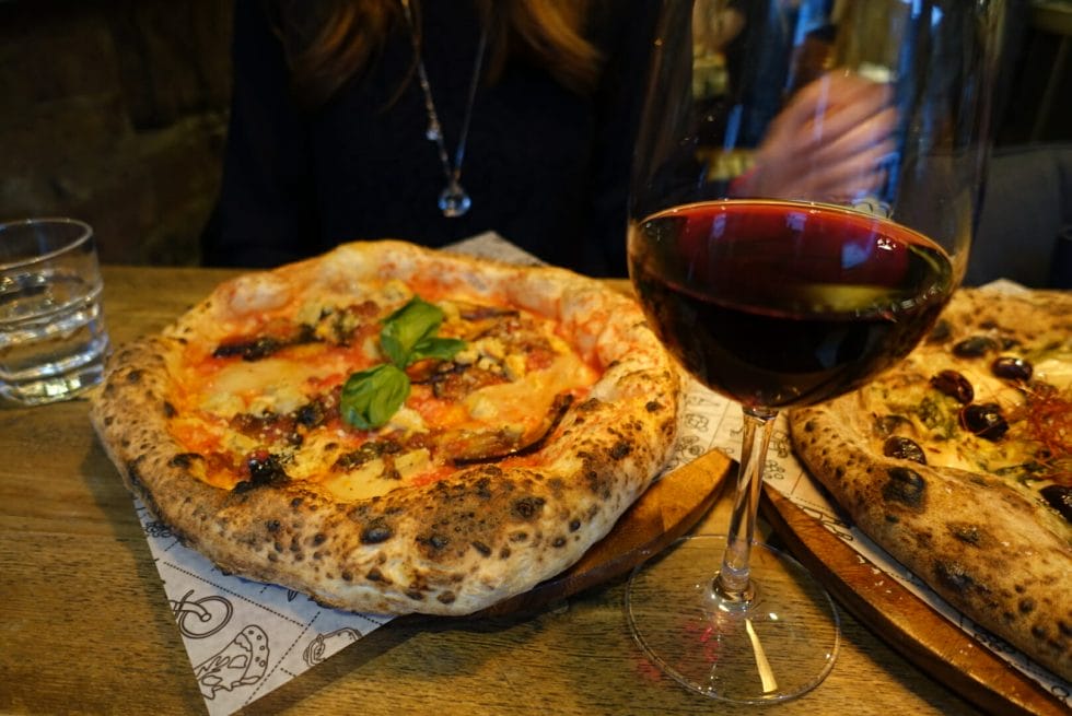 The aubergine pizza and glass of red wine