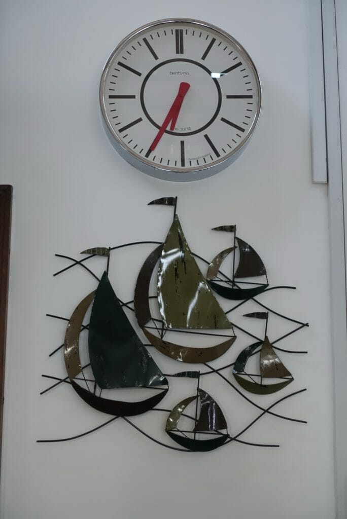 A metal decoration of boats on the wall