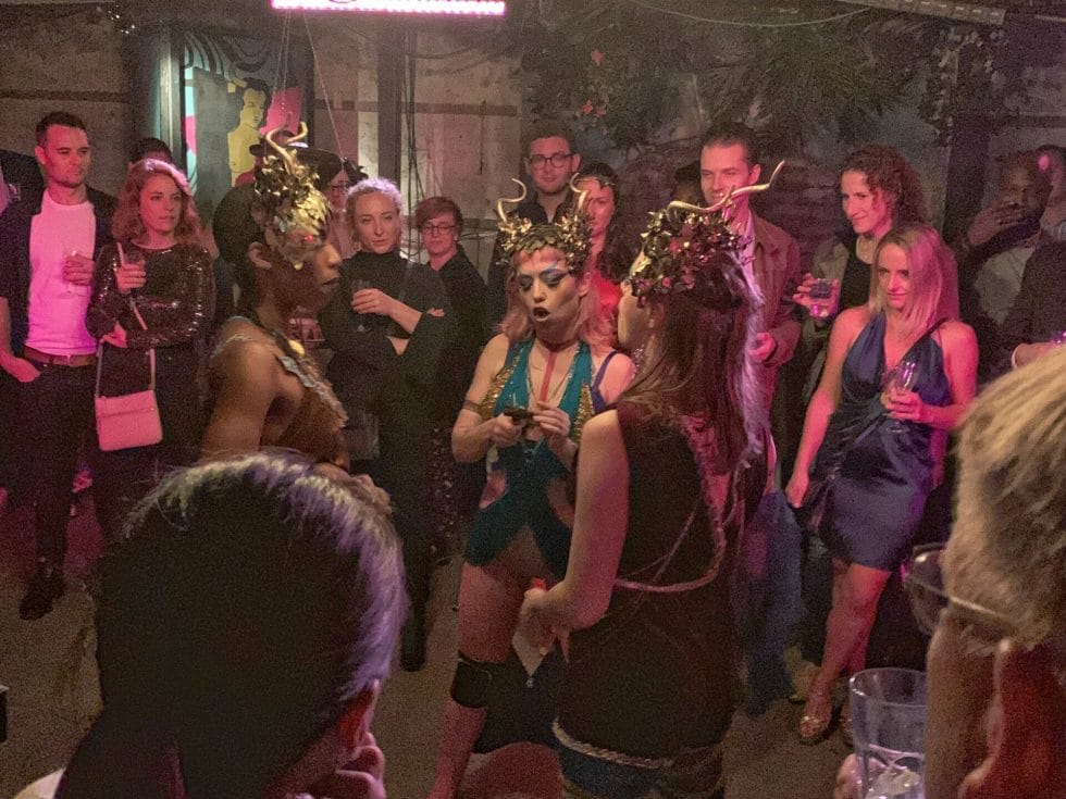 Three actresses dressed with horn headresses in an ancient Greek way