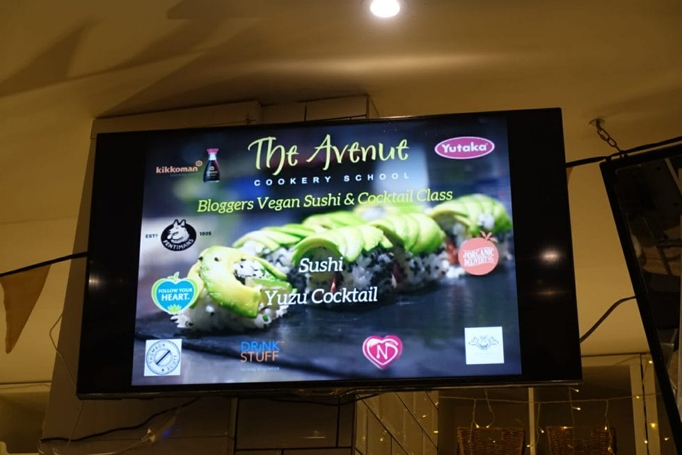 TV screen showing the bloggers vegan sushi and cocktail class info