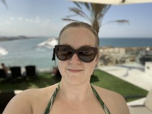 Katie in bikini with a view of the sea behind