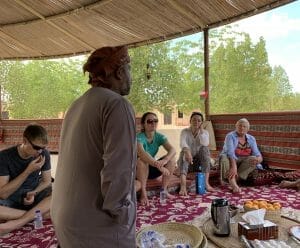 The group sitting on the traditional Omani carpets