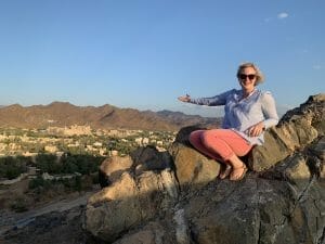 Katie wearing her flip-flops perched on a rocky ridge