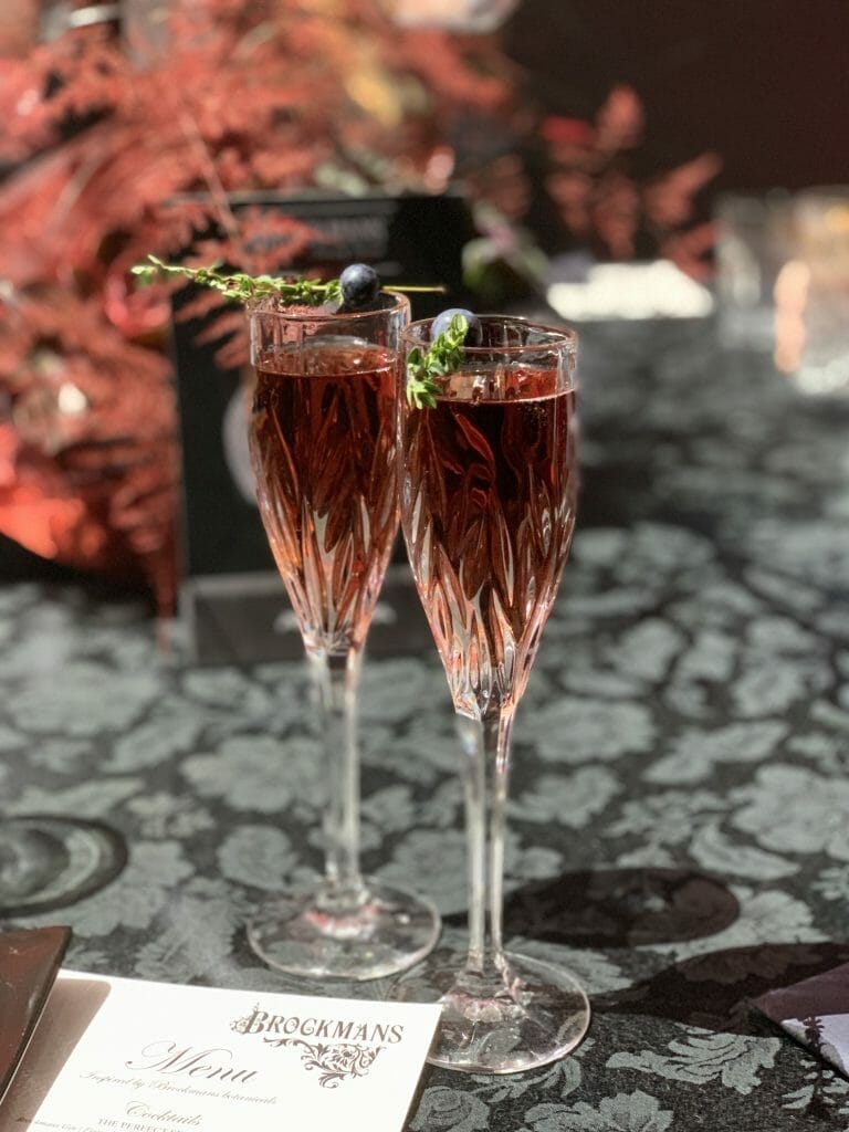 2 champagne glasses with Blackberry Ombre cocktails in them