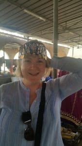 Katie modelling an embroidered headdress at Ibra women's market