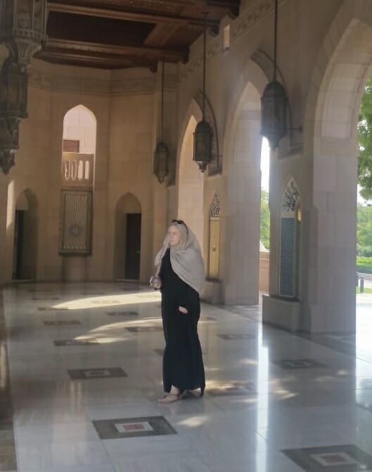 Katie walking in her abaya and head scarf at the Grand Mosque