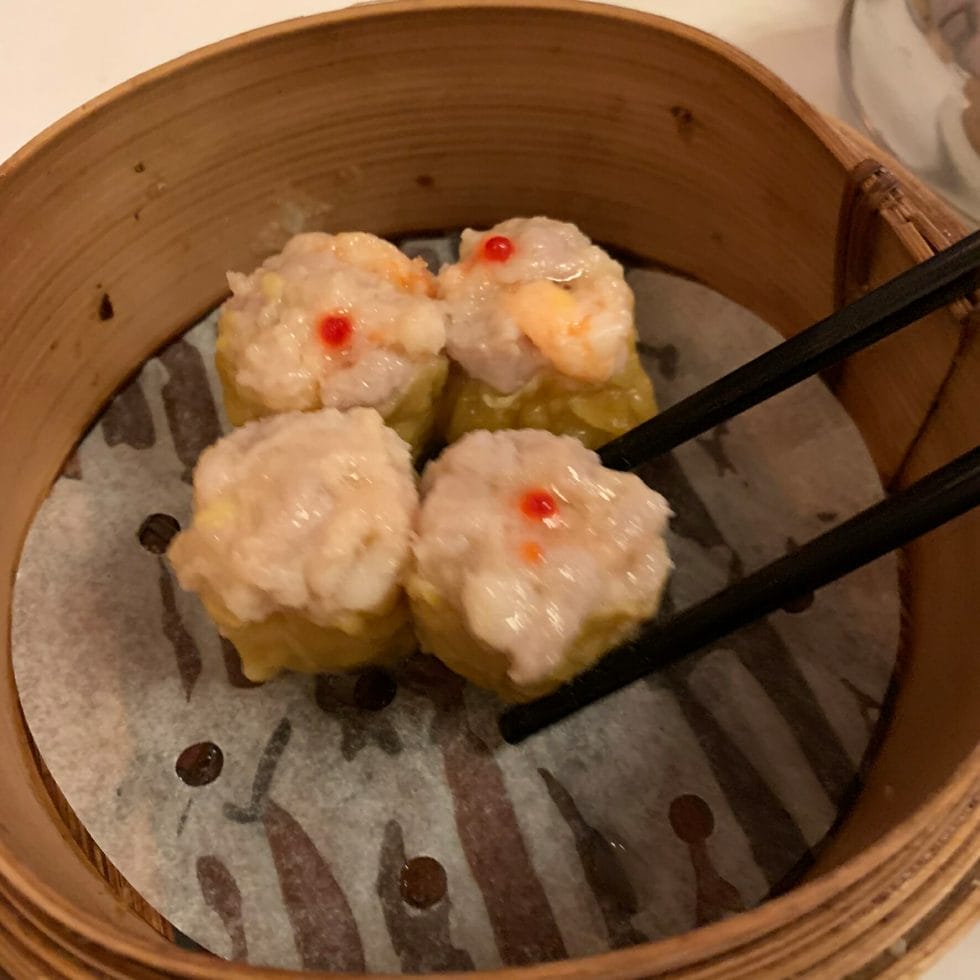 Siu Mai pork and prawn dumplings in the steamer with chopsticks