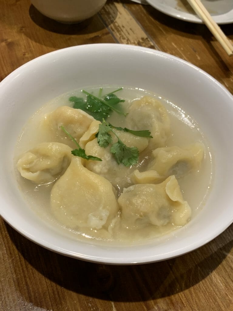 Soup with spicy chicken dumplings and coriander on top