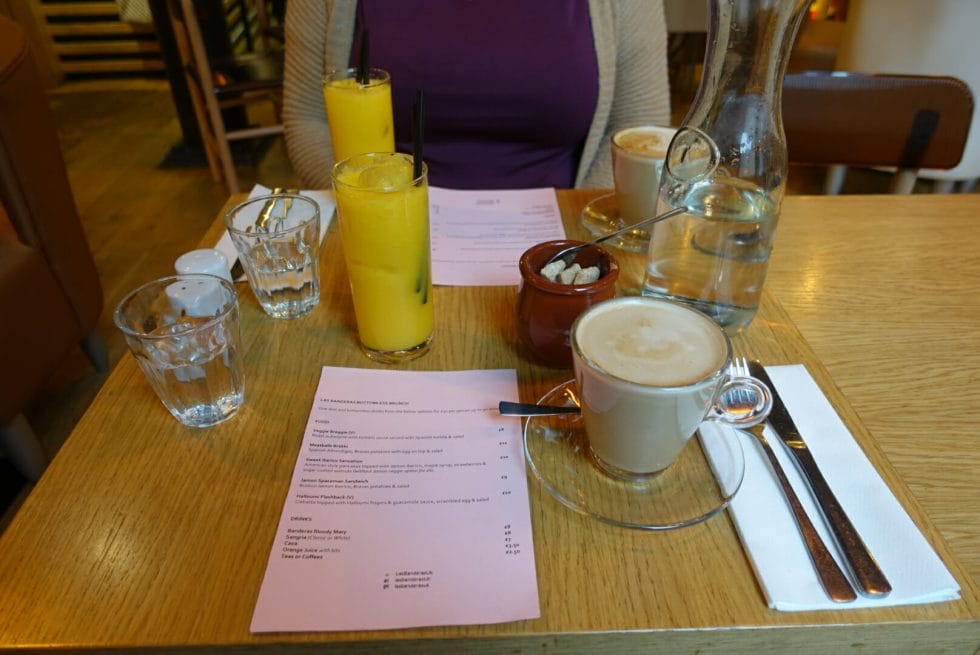 The brunch menu with orange juices and coffees on the table