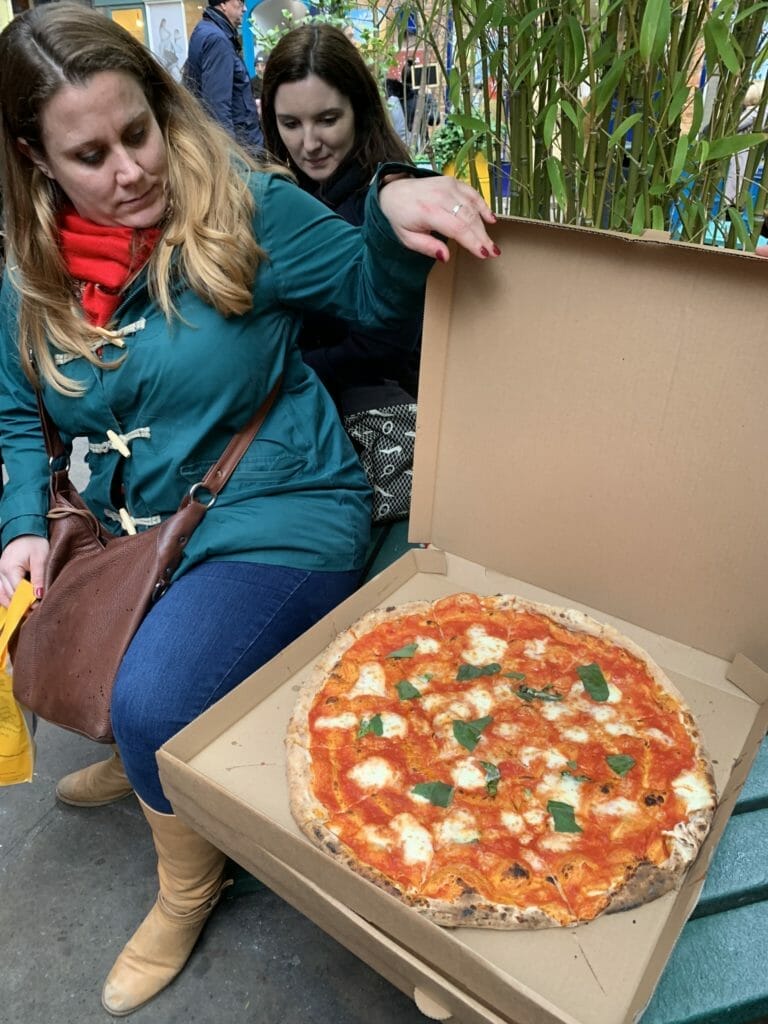 Full pizza box on a bench in Neals Yard