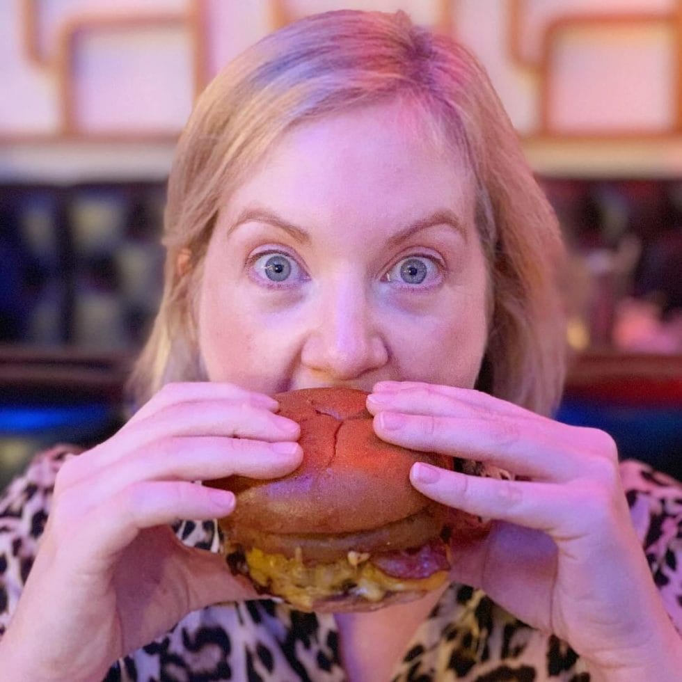 Katie digging into a burger