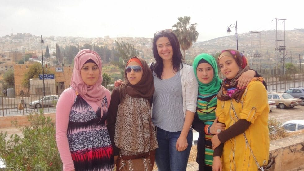 Katie's friend Cat posing with local Jordanian school girls at Jerash