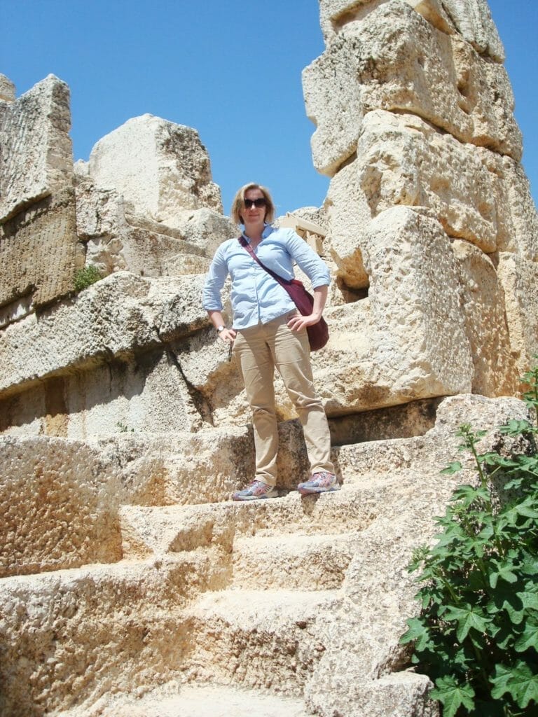Katie wearing a long sleeved cotton shirt on top of a vest top whilst in some ruins