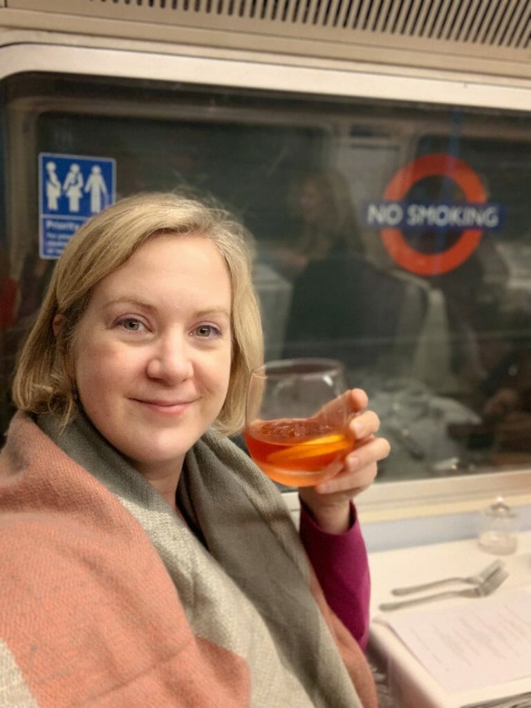 Katie drinking a negroni on the tube!