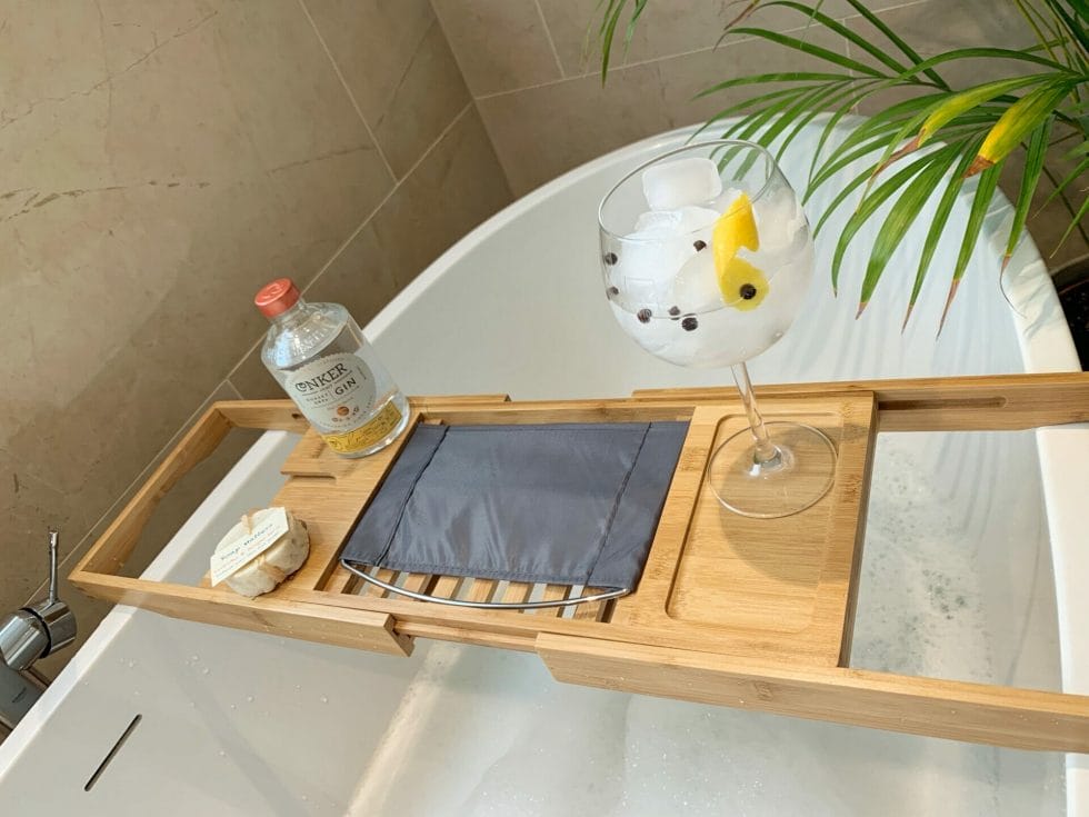 Gin and tonic, Conker Gin bottle and soap on the tray over the bath