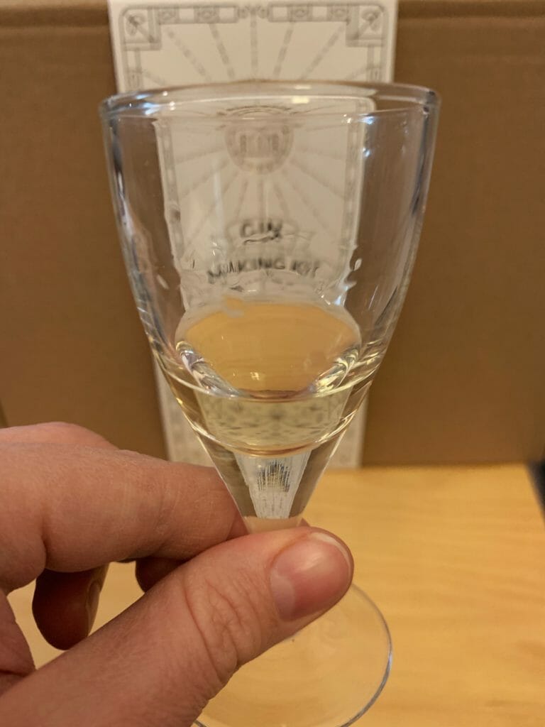 A small sample of the gin in a glass to show the golden colour