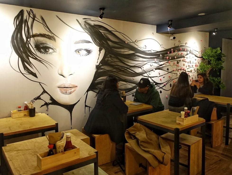 Mural of a girl with long dark hair flowing in the breeze