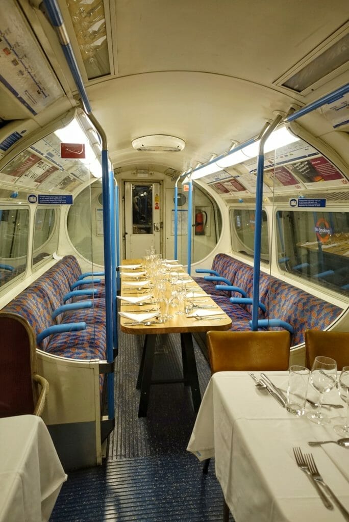 The large table for 12 set up between the tube seats
