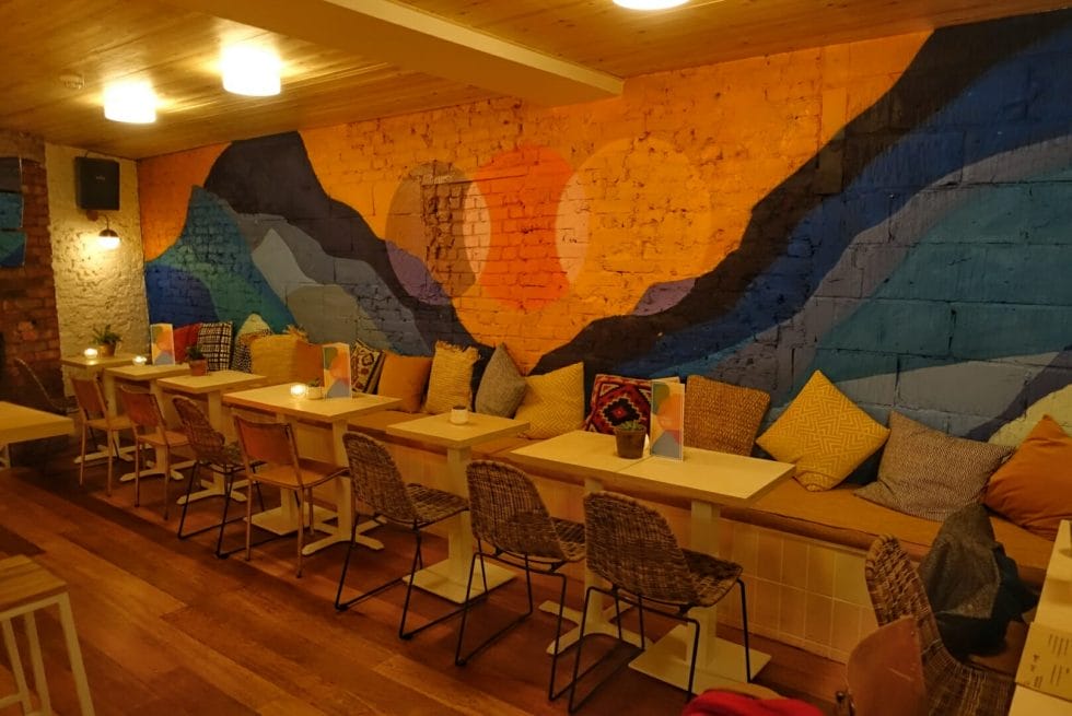 The colourful mural on the other side of the main bar room with low seating