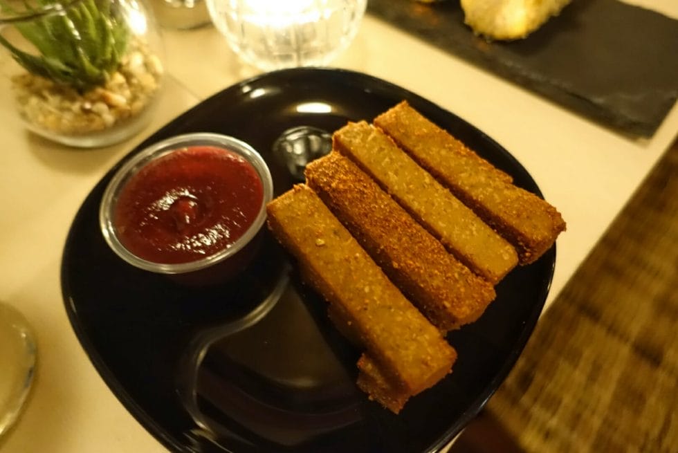 Polenta chips piled up next to the chipotle ketchup