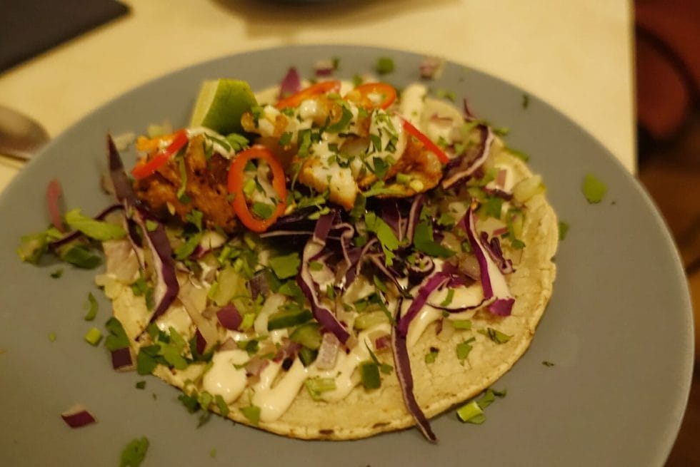 Grilled fish taco served with lime mayo and finely sliced red cabbage