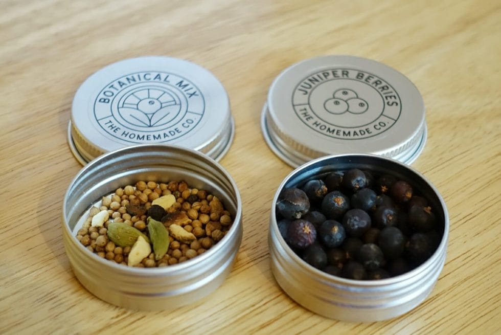 Close up of the open tins of botanicals showing the contents inside