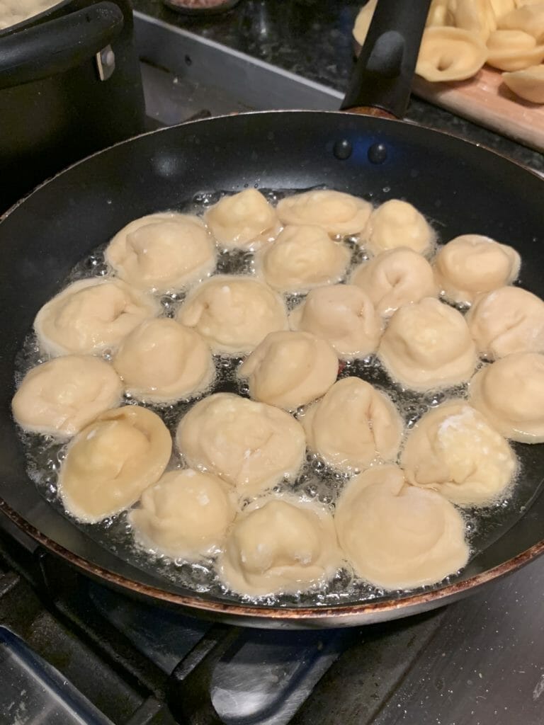 Cheese dumplings frying in butter