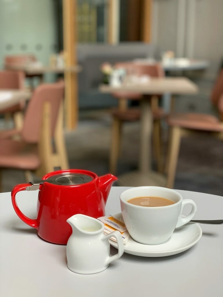Red teapot with milk jug and tea cup