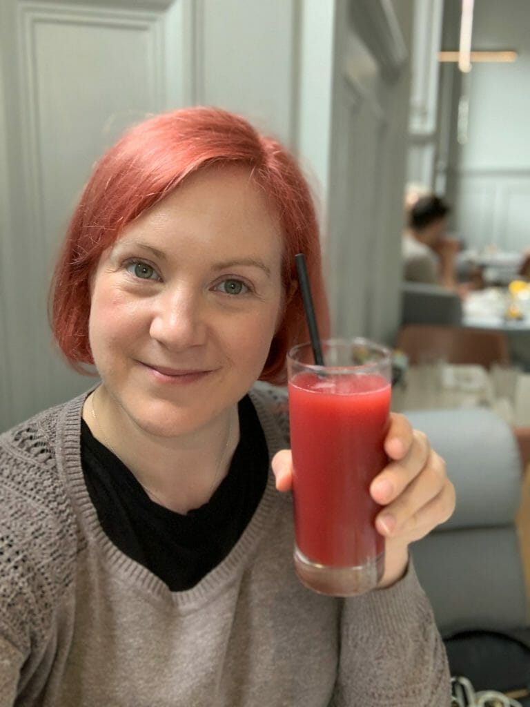 Katie with raspberry and apple juice almost matching her red hair!