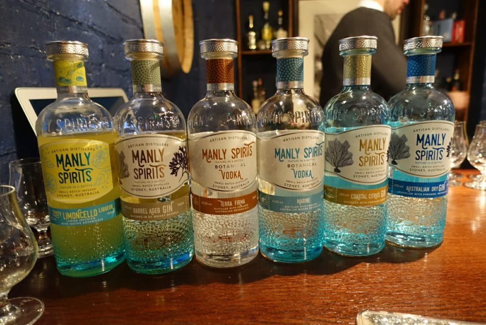 6 bottles of various Manly Spirits products lined up on a bar