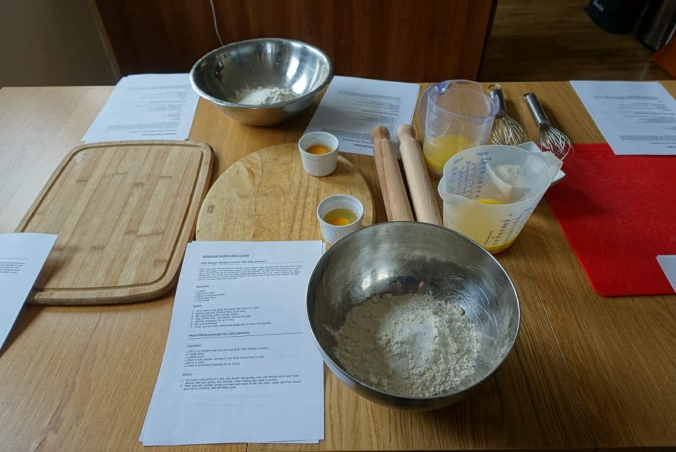 Dining table set up with pre-measured ingredients and equipment