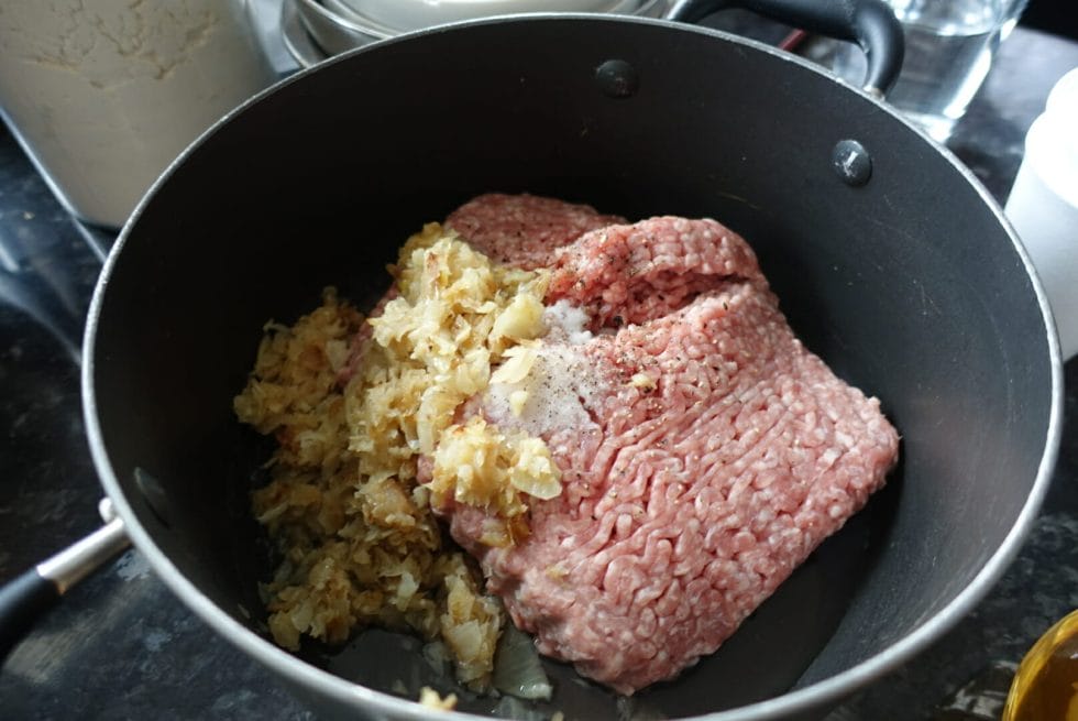 Raw pork mince with fried onions to be made into the meat filling