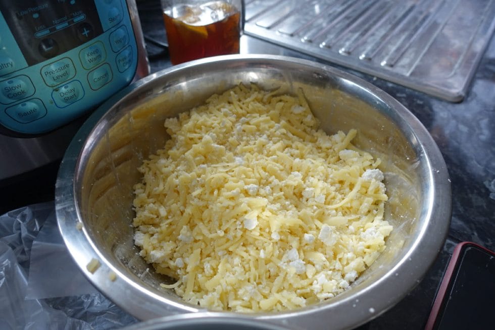 Grated and crumbled cheeses in a bowl