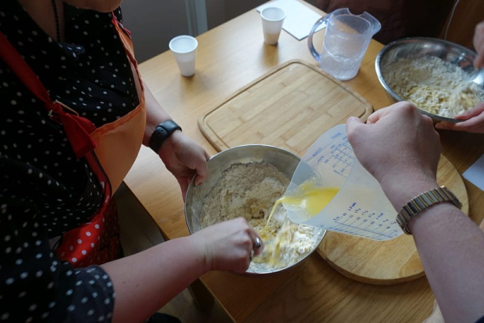 Combining the wet ingredients with the dry flour