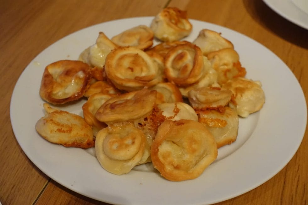 A plateful of crispy fried cheese dumplings with a lovely golden colour