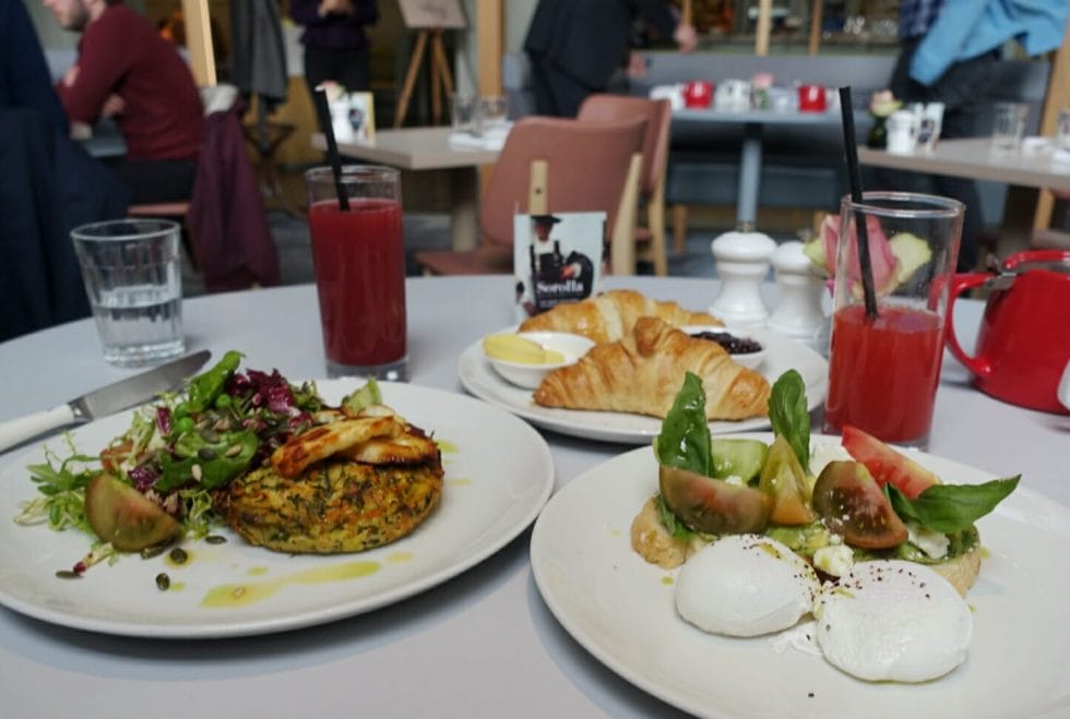 Plates of food, croissants and juices on the table
