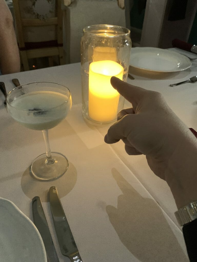 Katie's finger pointing at a electronic candle