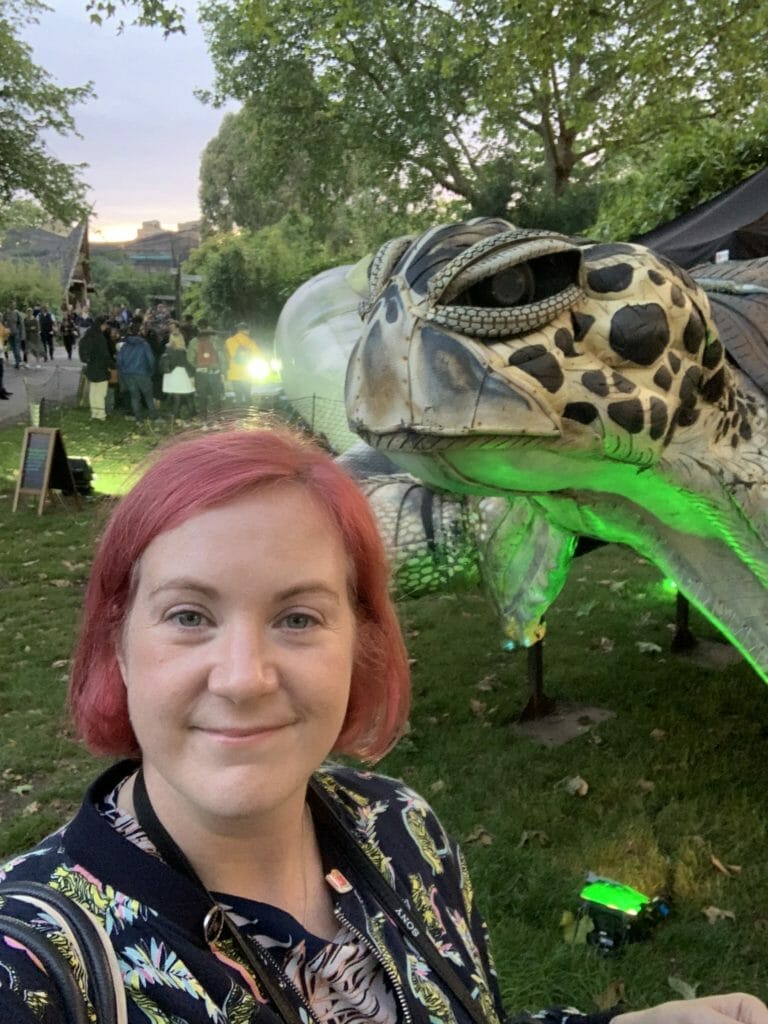Katie taking a selfie with the turtle statue