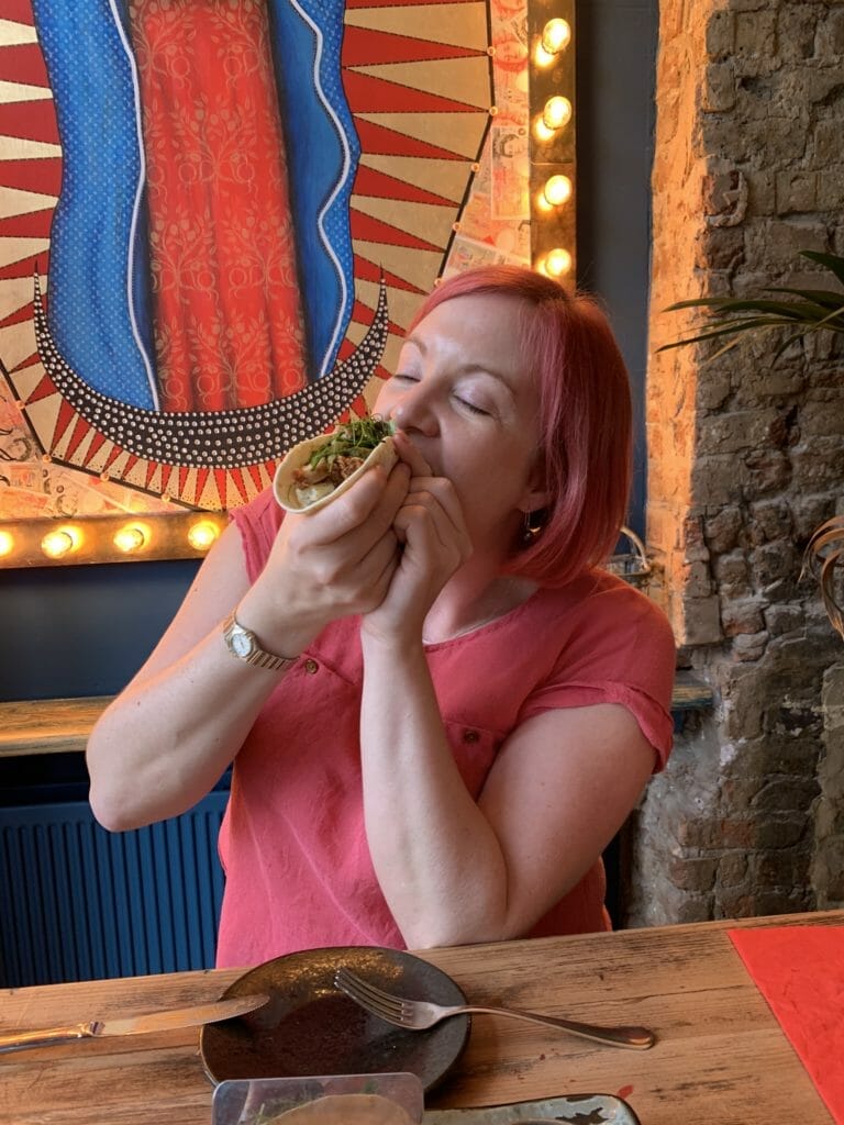 Katie attempting to eat the taco gracefully